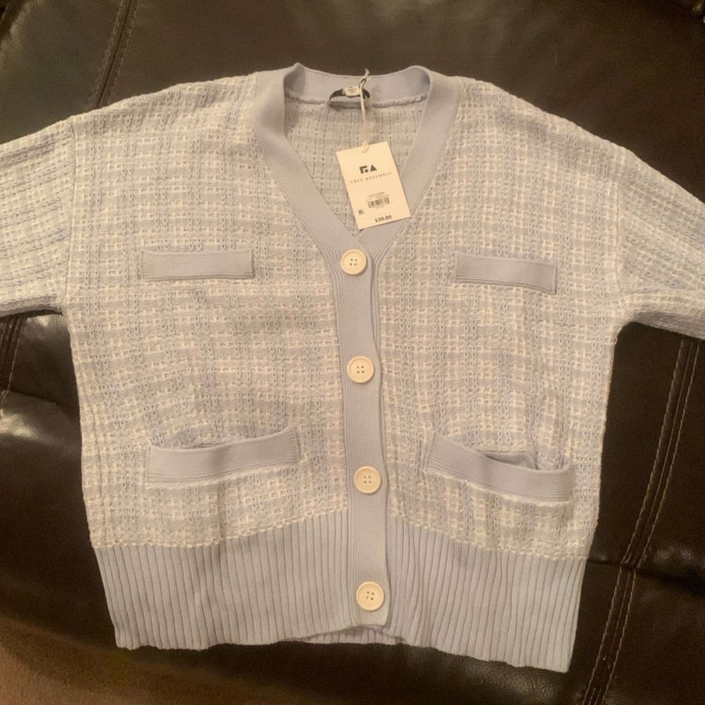 Very pretty cardigan sweater.  Light blue & white. New with tags.  NWT.  Medium.